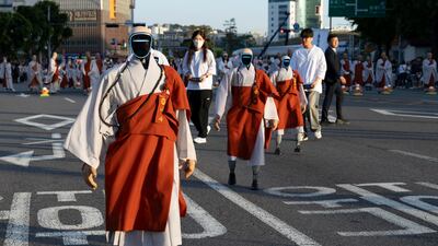 Humanoid robots dressed as Buddhist monks participate in a parade at the Buddha Era 2570 Lotus Lantern Festival in Seoul, South Korea. EPA