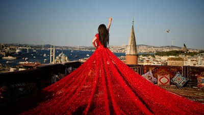 A model poses at an open-air studio overlooking the Bosphorus in Istanbul, Turkey, on July 19. AP