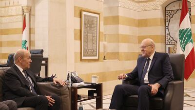 Lebanon's caretaker Prime Minister Najib Mikati (right) meets with French envoy Jean-Yves Le Drian in Beirut on November 29. AFP