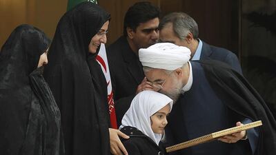 The Iranian president, Hassan Rouhani, kisses the head of Armita, daughter of assassinated Iranian scientist Darioush Rezaeinejad, during a news briefing after Iran and world powers came to an agreement in Geneva over its nuclear programme. Mohammad Berno / Iranian President’s Office via AP