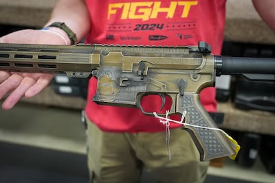 Former president Donald Trump's face is emblazoned on an AR-15 assault rifle. Joshua Longmore / The National