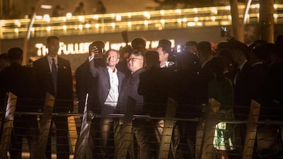 Singapore Minister for Foreign Affairs Vivian Balakrishnan (L) takes a selfie with North Korean leader Kim Jong-un walks along the Jubillee bridge during a late-night tour of Singapore.