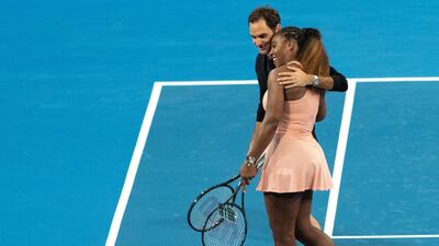 Roger Federer of Switzerland and Serena Williams of the USA leave the court after playing in the mixed doubles match. EPA