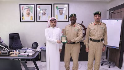 Abdulrazzaq bin Zaal bin Jabr Al Ruwaili is presented with a certificate by police. Photo: Dubai Police