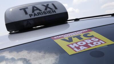 Above, a yellow ribbon indicates a striking Paris taxi. Taxi drivers in teamed up in large numbers to slow traffic to a snail’s pace on major motorway access routes into the capital. Philippe Wojazer / Reuters