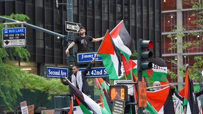 Protesters stand on a traffic light at a pro-Palestine rally in New York City on May 11, 2021. Joshua Longmore / The National