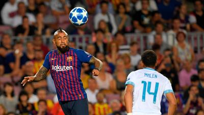 Barcelona's Arturo Vidal vies with PSV Eindhoven's Donyell Malen. AFP