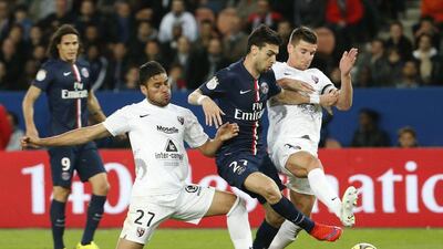 Paris Saint-Germain's Javier Pastore vies for the ball with Metz defenders during his side's Ligue 1 win on Tuesday night. Thomas Samson / AFP / April 28, 2015