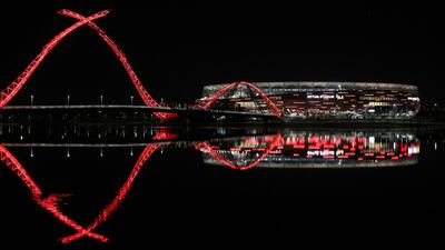 Optus Stadium is lit up in red lights to celebrate the upcoming games featuring Manchester United. EPA