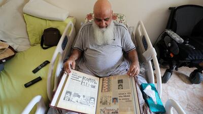 Mohammed Ishaq shows some old newspaper clippings from his playing career.