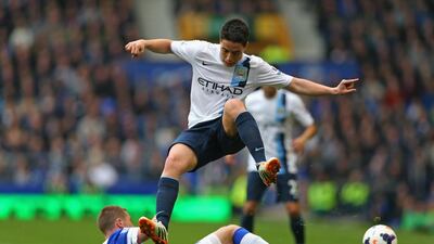 Samir Nasri, top, of Manchester City hurdles the tackle of James McCarthy of Everton during their Premier League match at Goodison Park on May 3, 2014. Clive Brunskill / Getty Images