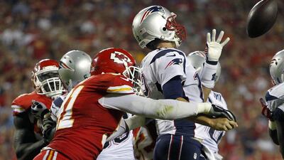Tamba Hali hits Tom Brady during the Chiefs' game against the New England Patriots on September 29, 2014. Colin E Braley / AP