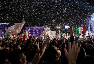 Supporters of the presidential candidate for the "Juntos haremos historia" coalition, Andres Manuel Lopez Obrador, celebrate at the Zocalo square in Mexico City, after getting the preliminary results of the general elections on July 1, 2018. Anti-establishment leftist Andres Manuel Lopez Obrador won Mexico's presidential election Sunday by a large margin, according to exit polls, in a landmark break with the parties that have governed for nearly a century. / AFP / Guillermo Arias