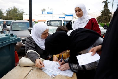 Syrians living in Lebanon wait outside the Ministry of Interior Immigration and Passports Department, at the Syrian-Lebanese border, as they return to Syria. Reuters