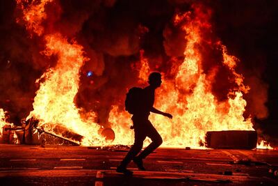 Fires burn following an evening of rioting as a general strike is called after a week of protests over the jail sentences given to separatist politicians by Spain's Supreme Court. Getty Images