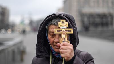 A Ukrainian woman prays on Independence Square in Kiev on Thursday. AFP