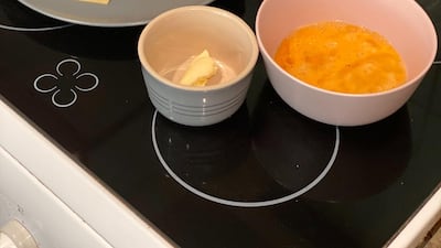 The ingredients you need for the TikTok one pan egg sandwich: two slices of bread, two beaten eggs, a knob of butter, salt, pepper and optional slices of cheese. Farah Andrews / The National