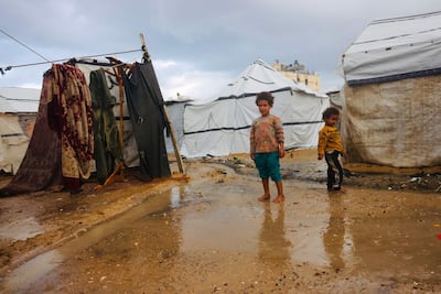The shattered lives of displaced Palestinian children have been compounded by the onset of wintry weather at a camp in Deir Al Balah, Gaza. AFP