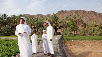 Khalifa Al Litbi (Far left) explains the traditional way of life on an Emirate farm in Wadi Al Tuwa. Behnd him stands Khalfan Al Dhagmani (Far Right), Mohammed Khalifa (second left and Saeed Al Kitbi (Second right).