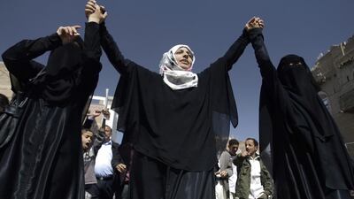 Yemeni activist Tawakkul Karman, centre, holds hands with other women during an anti-government protest in Sanaa. She was a joint winner of the 2011 Nobel Peace Prize for work on women’s rights. Hani Mohammed / AP