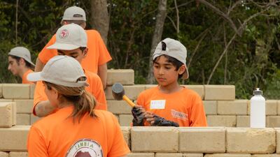 Dads and children from the UAE group worked together to help extend a school in Zambia, adding four classrooms and a solar powered computer lab. Courtesy, Fathers And Kids Camping