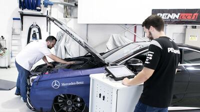 Mechanics work on a vehicle in Silber Arrows Garage. Mechanics say they are seeing an increasing number of vehicles that dupe the buyer into thinking they are newer than they are. Reem Mohammed / The National