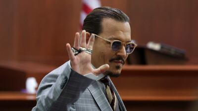 Depp waves to his courtroom fans. AFP