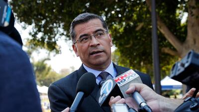 California Attorney General Xavier Becerra talks to reporters after a news conference at UCLA. President-elect Joe Biden has picked Mr Becerra to be his health secretary. AP Photo