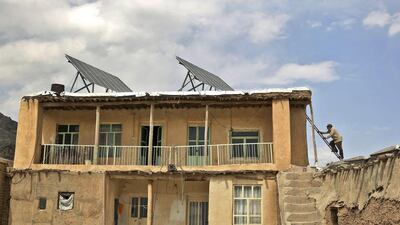 Rooftop solar panels on a house in Sichanloo, a hamlet 200 kilometres from Tehran, that were subsidised by the government. Ebrahim Noroozi / AP Photo / June 22, 2014
