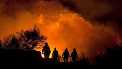 Firemen work to put out flames in Cualedro, Ourense, northwestern Spain. The Rural Resources Council declared emergency situation level two because flames from the fire are threatening homes in Cualedro. EPA