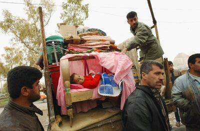 One-year-old Hosbug Zrar is loaded on to a trailer as his family flees Erbil in fear of a chemical attack. Getty Images