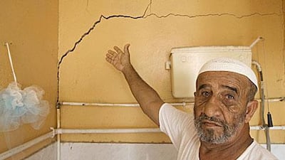 A homeowner points out damage in a bathroom that he believes was caused by blasting at quarries near his home in the village of Jerief.