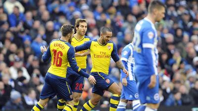 Arsenal's Theo Walcott, centre, celebrates after scoring his 2nd minute opening goal for Arsenal in their 3-2 FA Cup win against Brighton on Sunday. Gerry Penny / EPA