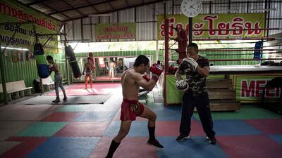 World Boxing Council (WBC) mini-flyweight champion, Wanheng Menayothin (C), doing pad work with his trainer during a training session in Bangkok. Lillian Suwanrumpha / AFP