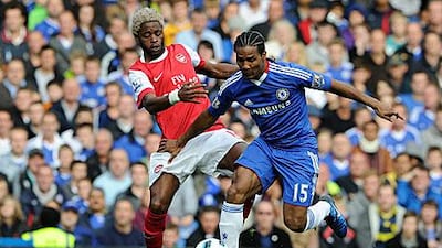 Chelsea’s Florent Malouda, right, fends off a challenge from Arsenal’s Alex Song.