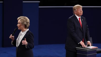 Democratic presidential nominee former Secretary of State Hillary Clinton (L) speaks as Republican presidential nominee Donald Trump listens during the town hall debate at Washington University. Win McNamee / Getty Images