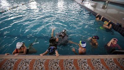 Young swimmers work on their technique, under the guidance of coach Elaf. Reuters