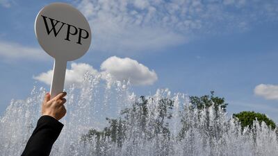 An usher holds a baton at the AGM of WPP in London. The company reported a rise in revenues. Reuters