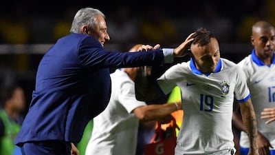 Brazil's Everton Soares celebrates with coach Tite after scoring against Bolivia. AFP