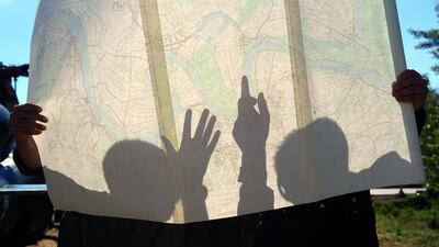 Helicopter pilots check a map of the flooded town of Obrenovac, 40 kilometres west of Belgrade. The Balkans braced for more misery as the death toll from the worst floods in a century rose to 47 and rising waters forced thousands more to flee their homes. Alexa Stankovis / AFP