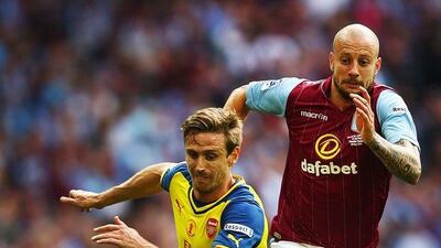 Nacho Monreal, left, of Arsenal is chased by Alan Hutton of Aston Villa during the FA Cup final between Aston Villa and Arsenal at Wembley Stadium on May 30, 2015 in London, England. (Photo by Clive Rose/Getty Images)
