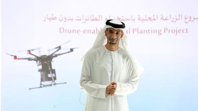 Dr Thani Al Zeyoudi, Minister of Climate Change and Environment, unveils plans for mangrove-planting drones to boost the country's coastline at an event held at Emirates Towers in Dubai. Pawan Singh/The National