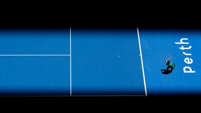 Thanasi Kokkinakis of Australia plays a backhand to Vasek Pospisil of Canada in the men's singles match on day two of the 2018 Hopman Cup at Perth Arena. Will Russell / Getty Images