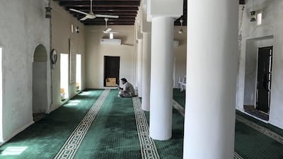 Traditional wooden beams support the ceiling of Al Aqroubi Mosque in a sleepy area of Sharjah. Pawan Singh / The National