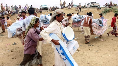Yemenis displaced from areas near the border with Saudi Arabia receive humanitarian aid given by the Norwegian Refugee Council (NRC) and the UN High Commissioner for Refugees (UNHCR) in the northern province of Hajja on March 11, 2019. AFP