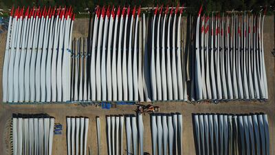 Workers check the quality of newly-manufactured wind turbine blades at a factory in Lianyungang in China's eastern Jiangsu province. AFP