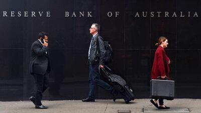 Pedestrians walk past the Reserve Bank of Australia (RBA) headquarters building in Sydney. Paul Miller / EPA