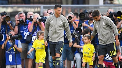 Juventus' forward Cristiano Ronaldo and Paulo Dybala enter the pitch. AFP