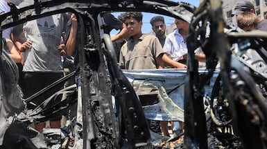 People surround a vehicle hit by an Israeli strike in Gaza city on Monday. Reuters