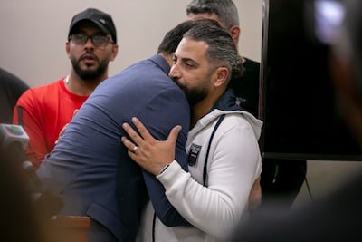 Illinois politician Abdelnasser Rashid embraces Odey Al Fayoume, father of Wadea Al Fayoume, at the Muslim Community Centre in Chicago. AP